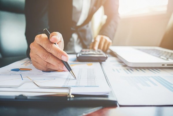 cooperation-analyst-chart-professional-paper-economics "Financial analysis with documents and laptop."